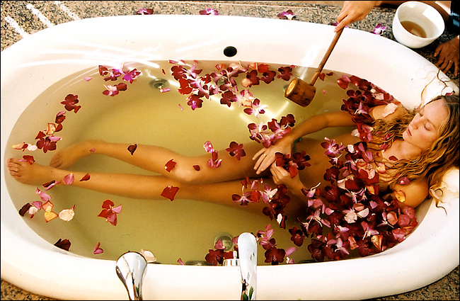 Tourist Nina Hupp in a bath of brewed rose tea and rose petals, recommended for relaxation and stress relief after which the treatment ends with rose lotion, a Maui luxury spa, April 2004.